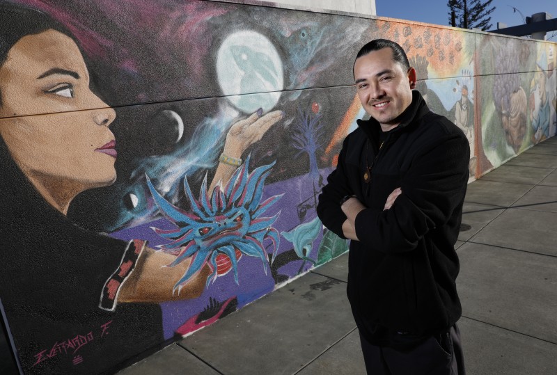 Emmanuel Morales is one of three artists that helped to create a mural celebrating diversity, native culture, and the immigrant experience on a wall which had been previously vandalized with pro-Trump sentiments. Photo taken at Cali Calmecac Language Academy on Friday, January 13, 2017 in Windsor, California . (BETH SCHLANKER/