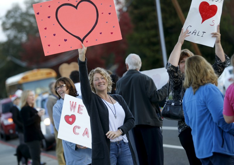 In response to recent vandalism, community members including Susan Nelson show their support for Cali Calmecac Language Academy before the start of class in Windsor, on Wednesday, October 26, 2016. (BETH SCHLANKER