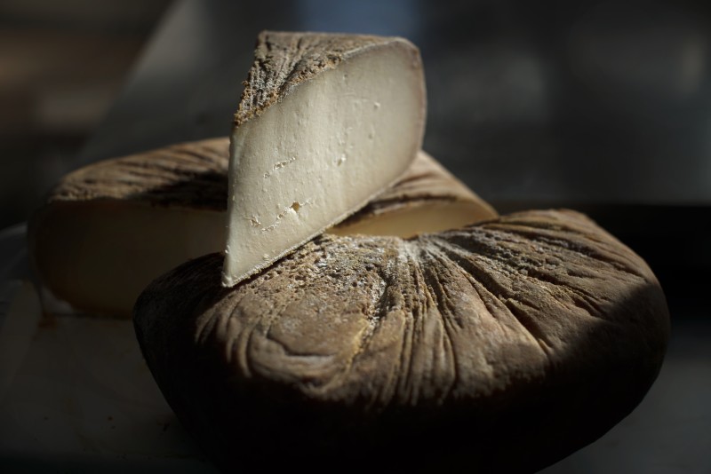 A wheel of Capricious cheese which is a hand-rolled washed rind goat cheese that is rubbed with olive oil during the aging process at Achadinha Cheese Company in Petaluma. January 26, 2017. (Photo: Erik Castro