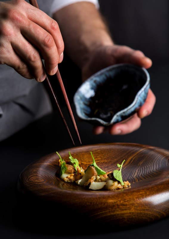 Carefully plating Sunchoke with Preserved Lemon, Mangalitsa Jowl, and Pine Nuts at Single Thread Farms Restaurant in Healdsburg. (John Burgess)