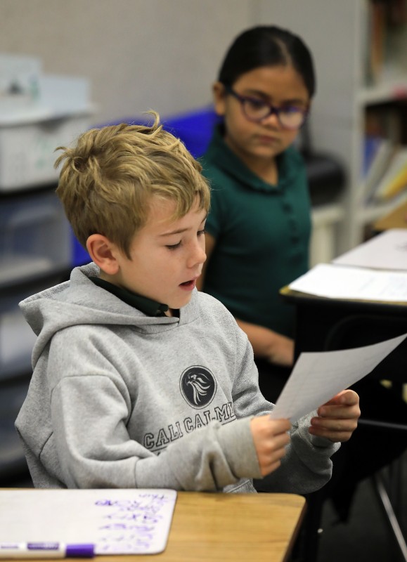 Cali Calmecac Language Academy third grader's in Rosa Villalpondo class wrote formal letters to President Donald Trump or outgoing President Barak Obama on inauguration day. Liam Wallace, 8, reads his letter to the class. (John Burgess