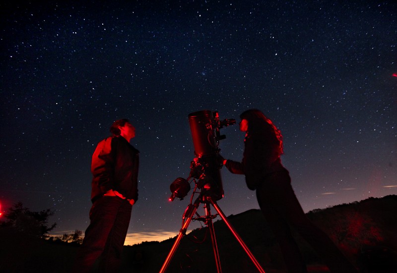 SRJC astronomy students Marcos Indalecio, left, and Melanie Queiroz view the stars through a telescope belonging to amateur astronomer Dickson Yeager during the monthly public viewing night at the Ferguson Observatory in Sugarloaf Park. In addition to three permanent large telescopes, members of the observatory often bring their personal scopes for the public to enjoy. John Burgess