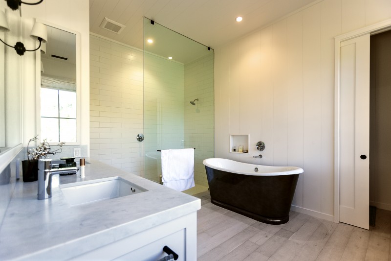 The steam shower and standalone soaking tub in the master bath were inspired by Muscatine’s love of Turkish hammams. Marble tile and a restrained white and gray palette continue the restful theme. Chris Hardy)