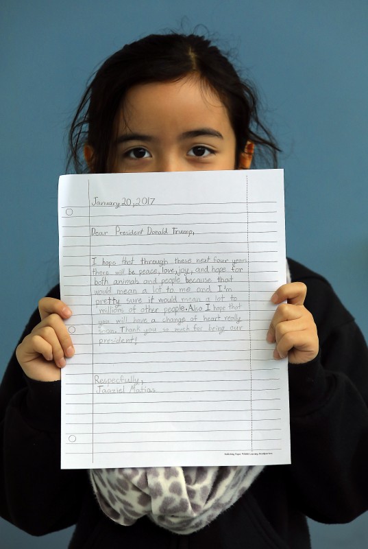 Cali Calmécac Language Academy third-grader Jaaziel Matias, 8, holds a letter she wrote to President Donald Trump on Inauguration Day. (John Burgess)