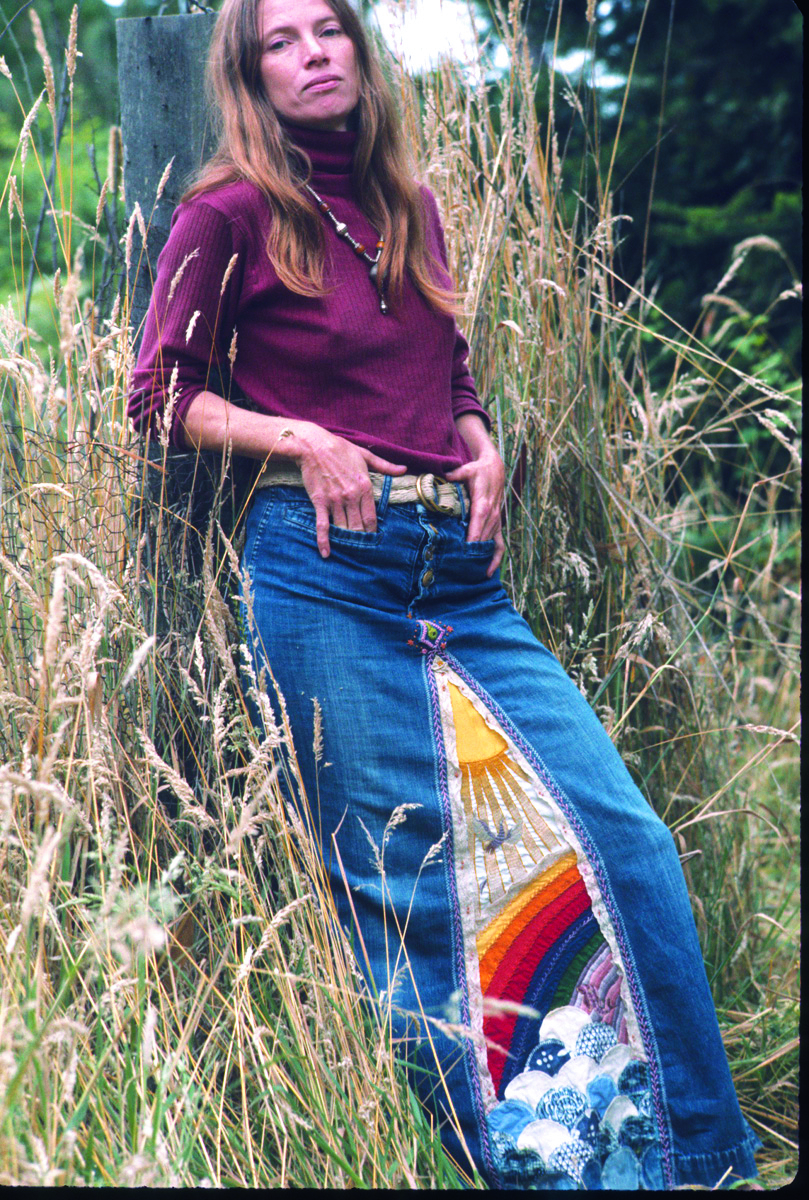 Rain Jacopetti in her Day and Night jean skirt, made for a traveling exhibit of her creative hippie clothing in 1974. In the communes, colorful patchwork and intricate embroidery transformed worn clothing into chic fashion. (Photo by Jerry Wainwright)