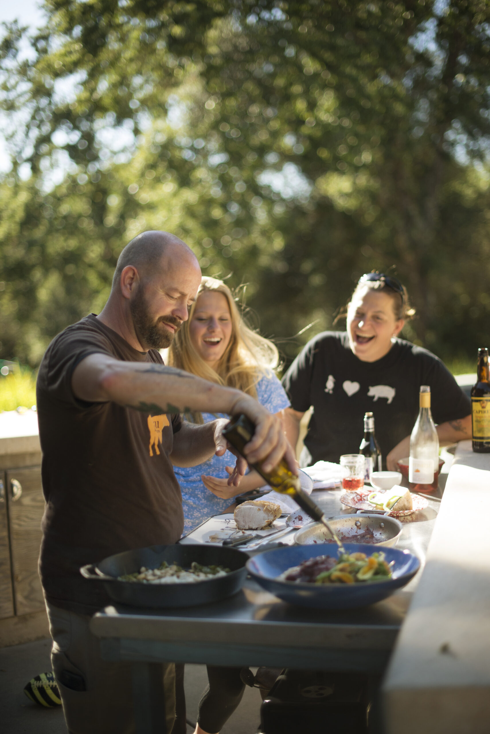 John Stewart and Duskie Estes cooking with their daughter Brydie Stewart, 15, at their home in Forestville, California. June 18, 2016. (Photo: Erik Castro/for Sonoma Magazine)