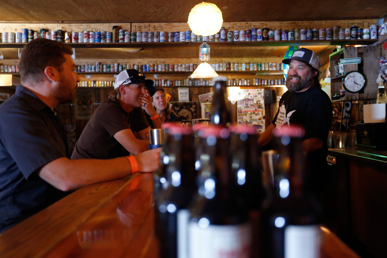 Lagunitas' Mr. Nice Guy (aka brand ambassador) Don Chartier, right, talks with visitors before a special tasting in the Lagunitas Loft at Lagunitas Brewing Company in Petaluma, California on Tuesday, August 9, 2016. (Alvin Jornada / The Press Democrat)