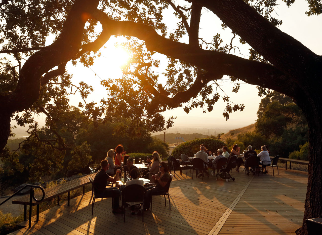 Guests enjoy wine and music as the sun sets at Paradise Ridge Winery in Santa Rosa, California, on Wednesday, August 9, 2017. (Alvin Jornada / The Press Democrat)