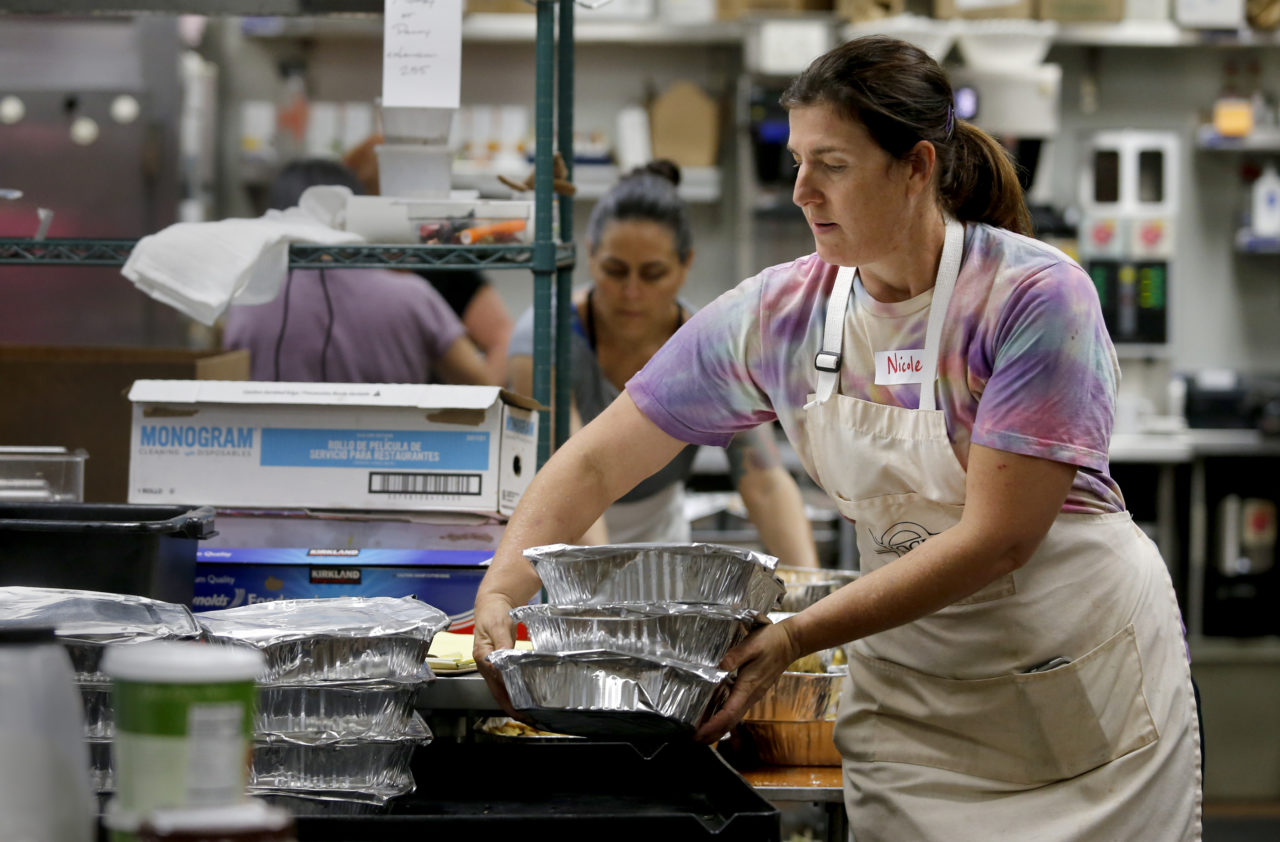 Nicole Saadeh, a volunteer with Sonoma Family Meal, helps package bread pudding in the kitchen of the Vintners Inn in Fulton, on Tuesday, October 24, 2017. (Photo by Beth Schlanker)