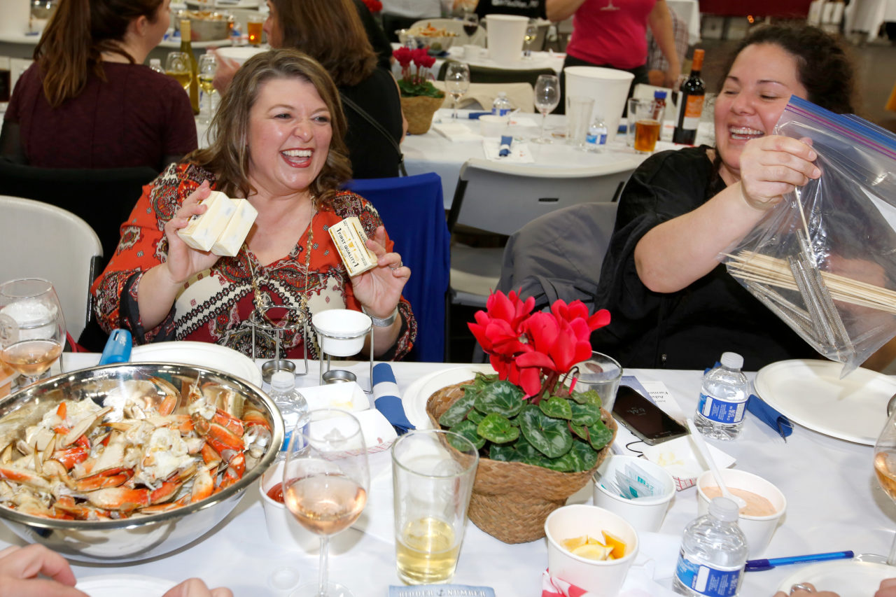 Crab feed veterans Teresa Thomas-Nett, left, and Julie Corralejo come prepared with butter, butter warmers and crab crackers for their table during the Sonoma County Farm Bureau's 29th annual Great Sonoma Crab and Wine Fest at Grace Pavilion in Santa Rosa, California, on Saturday, February 3, 2018. (Alvin Jornada / The Press Democrat)