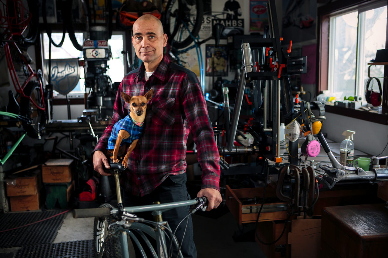 Curtis Inglis, in his workshop and with his dog Coco