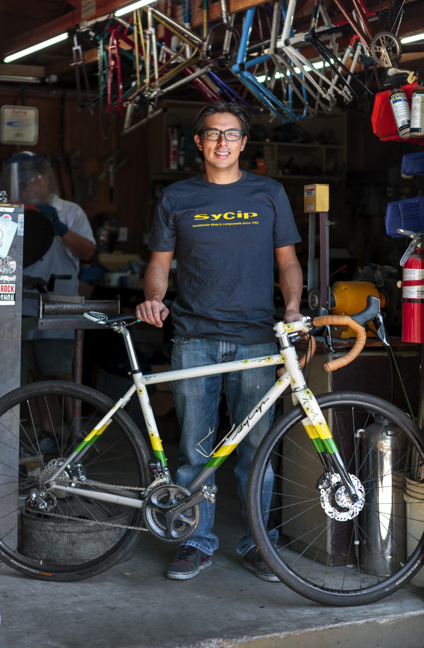 Jeremy Sycip, builder of custom bikes with some of his bikes and an exploded view of a bike