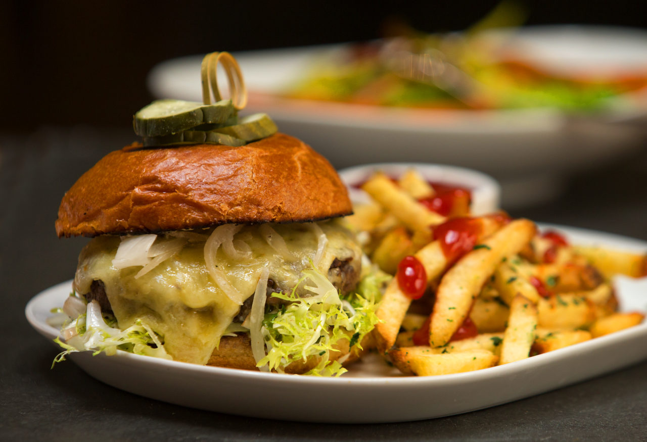 Sonoma Magazine-Eat Here Now. House burger with aged cheddar, frisee, pickled onion, aioli and house fries from the Perch and Plow on Courthouse Square in Santa Rosa. (photo by John Burgess/The Press Democrat)