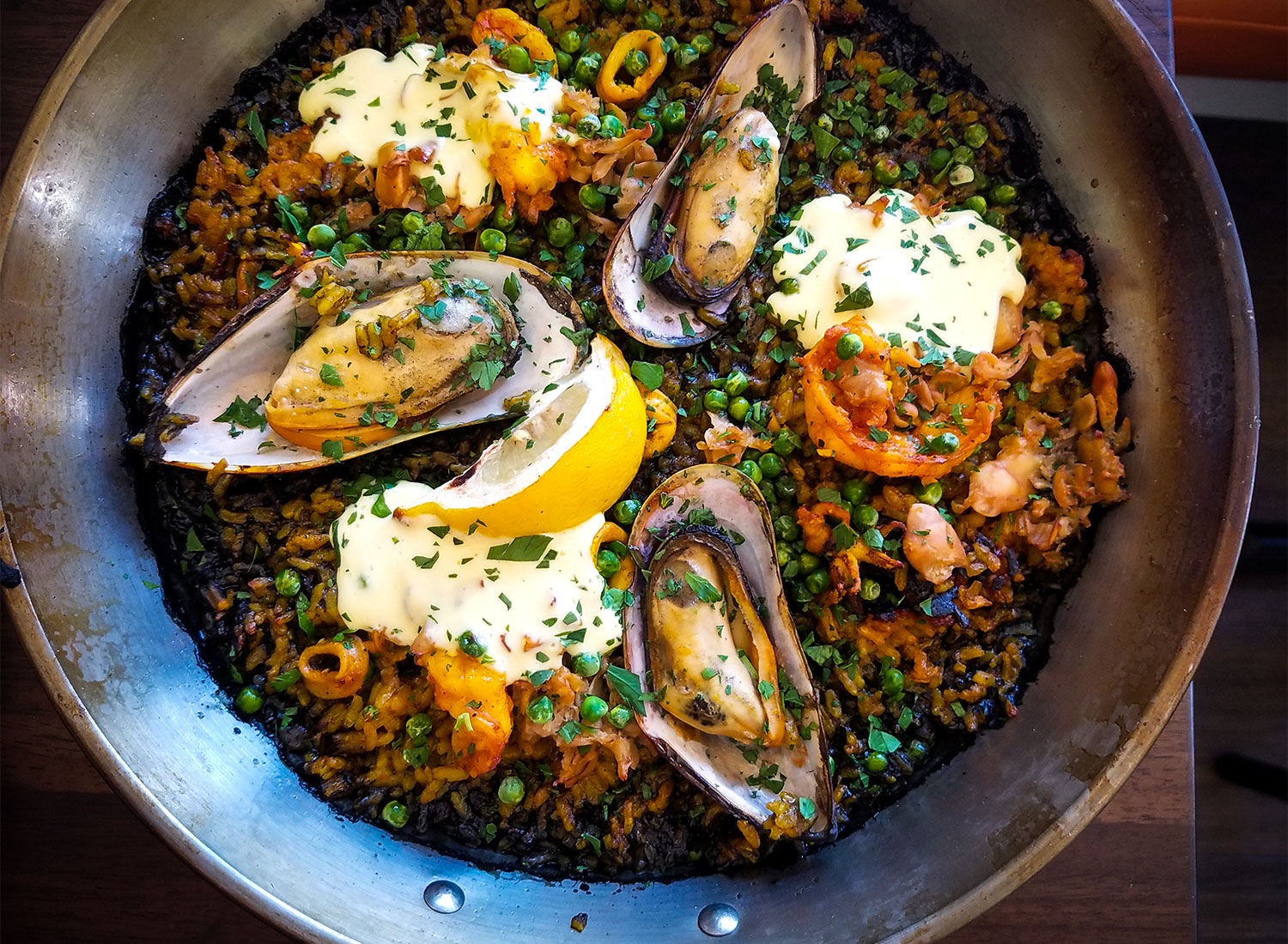 El Pescador paella with sea clams, mussels, prawns, squid, sweet peas, arroz negro, peppers and aioli at Gerards Paella Y Tapas in Santa Rosa. Heather Irwin/PD