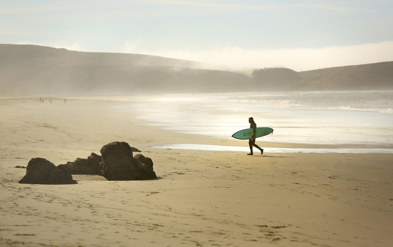 Martin Gilbertson walks back to his car after a morning session surfing the cold Pacific Waters along Dillon Beach. (Photo by Conner Jay)