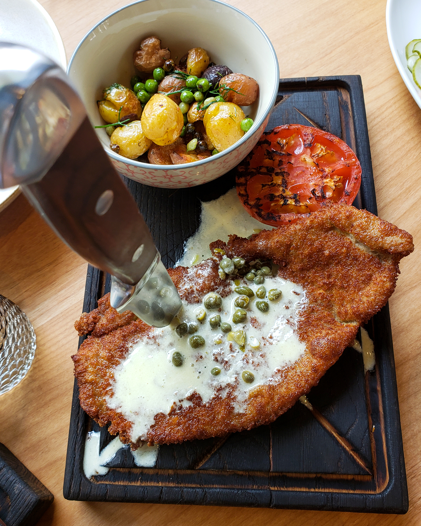 Weinerschnitzel with buttered potatoes and peas at Stockhome Restaurant in Petaluma. heather irwin/PD