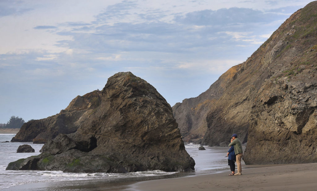 Aimi and Leon Gallego, of San Jose, enjoy the view from the beach, near the Pinnacle Gulch Coastal Access Trail, south of Bodega Bay on Tuesday, January 2, 2018. (Christopher Chung/ The Press Democrat)