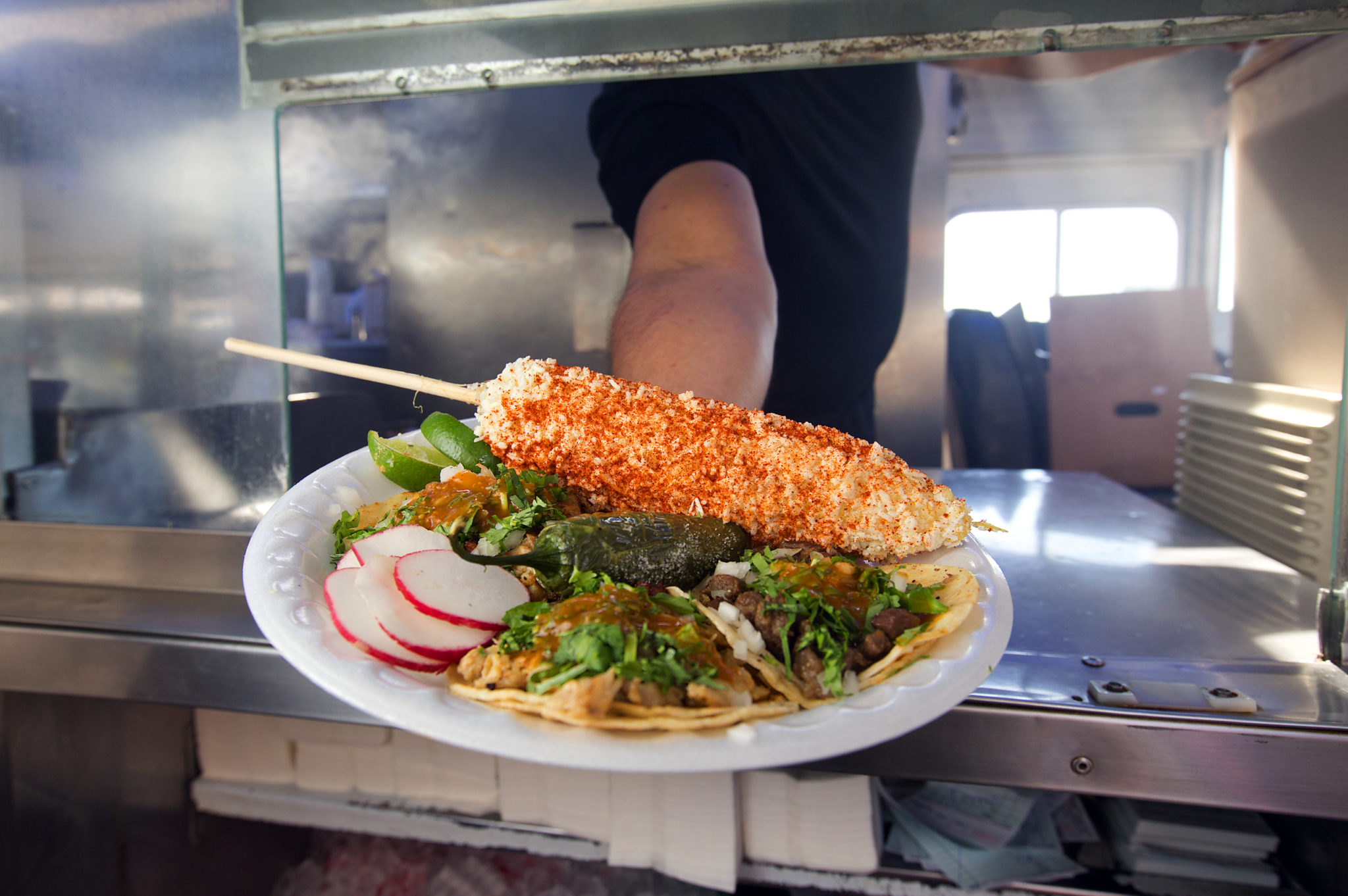Carnitas, asada and chicken street tacos with an elote with mayo, cotija and red chile from the Delicias Elenita taco truck on Sebastopol Avenue in Santa Rosa. (John Burgess/The Press Democrat)