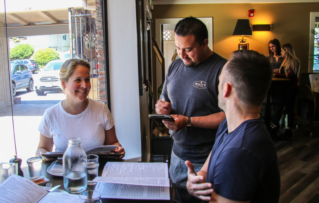 Servers at Willi's Wine Bar in Santa Rosa on opening day of the new location after the Tubbs Fire. Heather Irwin/PD