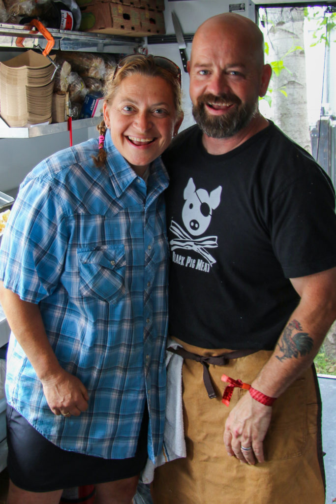 Chef Duskie Estes and John Stewart with their catering chef, Chris, on their Black Pig food truck in the VIP area at BottleRock 2019. Heather Irwin/PD