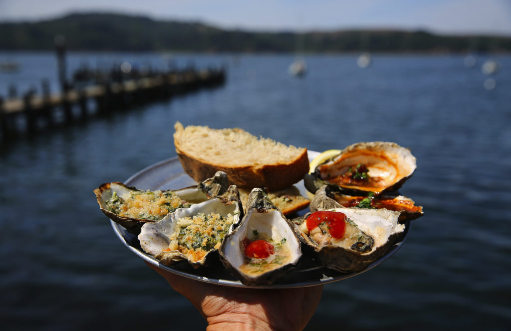 A sampler plate of Rockefeller, left, barbecued, and Kilpatrick oysters at The Marshall Store. (Christopher Chung / The Press Democrat)