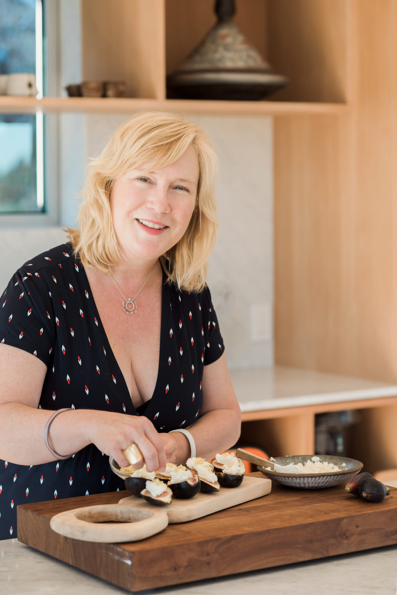 Chef Hollie Green Rottman loves bringing her cooking talents home and especially loves cooking Mediterranean cuisine. Here she is making figs with marsclpon/ honey spread topped with lemon zest.