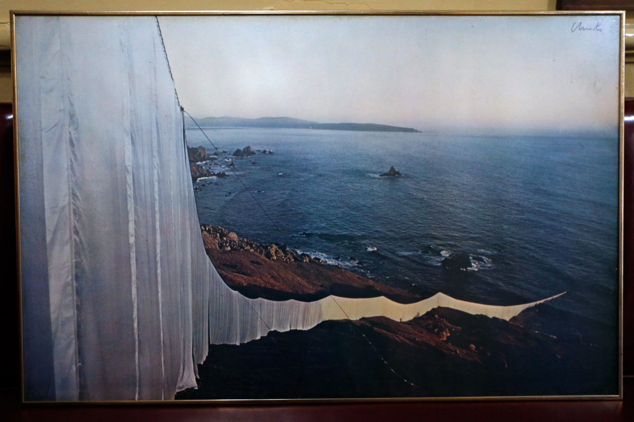 A signed photograph of Christo's "Running Fence," which is displayed at the Union Hotel Restaurant, where the artist frequented while constructing his 1976 installation art piece, in Occidental on Tuesday, July 26, 2016. This photograph shows the "Running Fence" where it enters the Pacific Ocean near Bodega Bay. (Alvin Jornada / The Press Democrat)