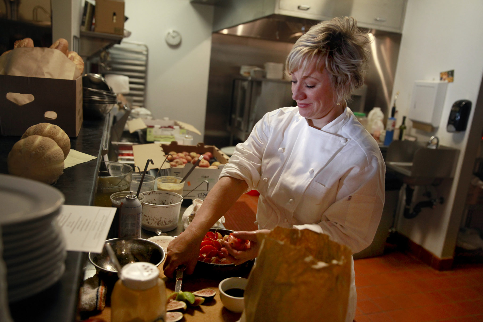 K&L Bistro owner Karen Martin makes a almond cake with fresh pluots in Sebastopol, on Tuesday, June 24, 2014.(BETH SCHLANKER/ The Press Democrat)