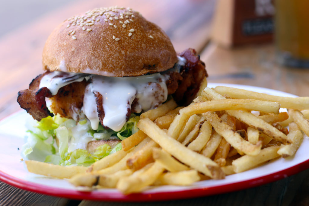 Fried chicken sandwich with goat cheddar, romaine, garlic mayo, bacon, Della Fattoria bun at Brewsters Beer Garden in Petaluma. (Heather Irwin/Sonoma Magazine)