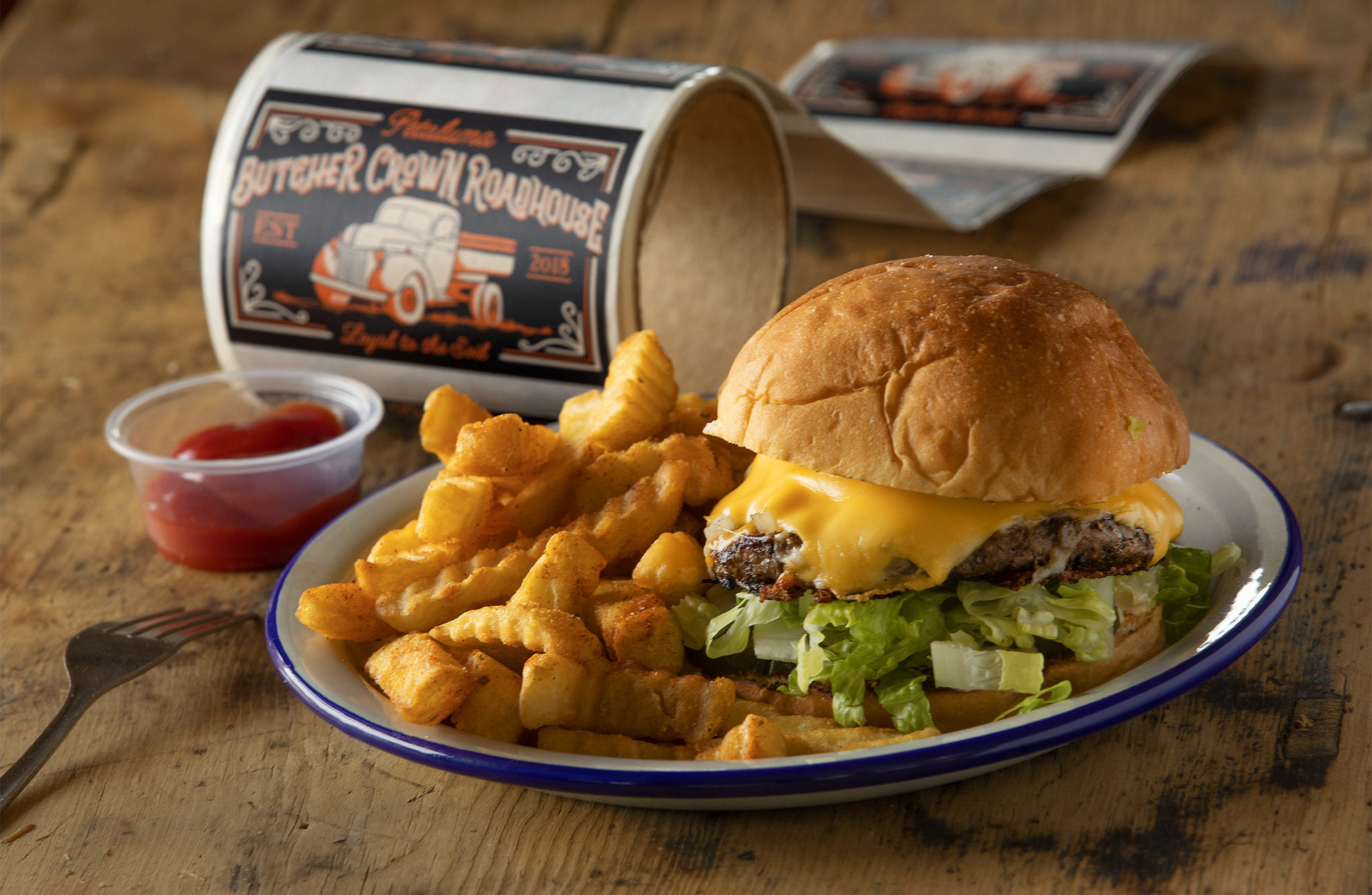The Butcher Burger with house American, cheddar and jack cheese, iceberg lettuce, smoked 'n' grilled onions and pickles from the Butcher Crown Roadhouse in Petaluma. (John Burgess / The Press Democrat)