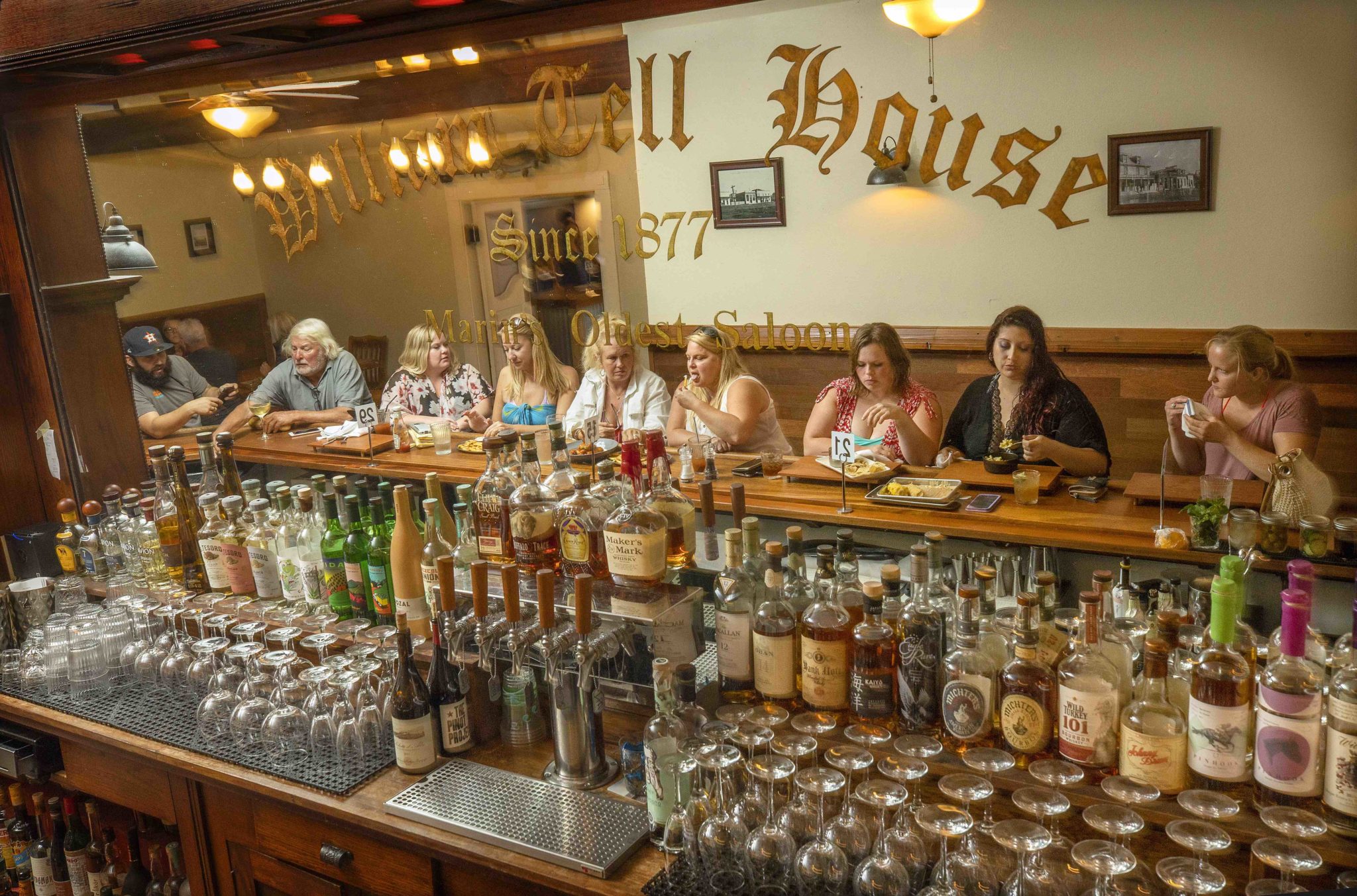Local friends enjoy a a drink and appetizers at the bar at the William Tell House in Tomales. (John Burgess/The Press Democrat)