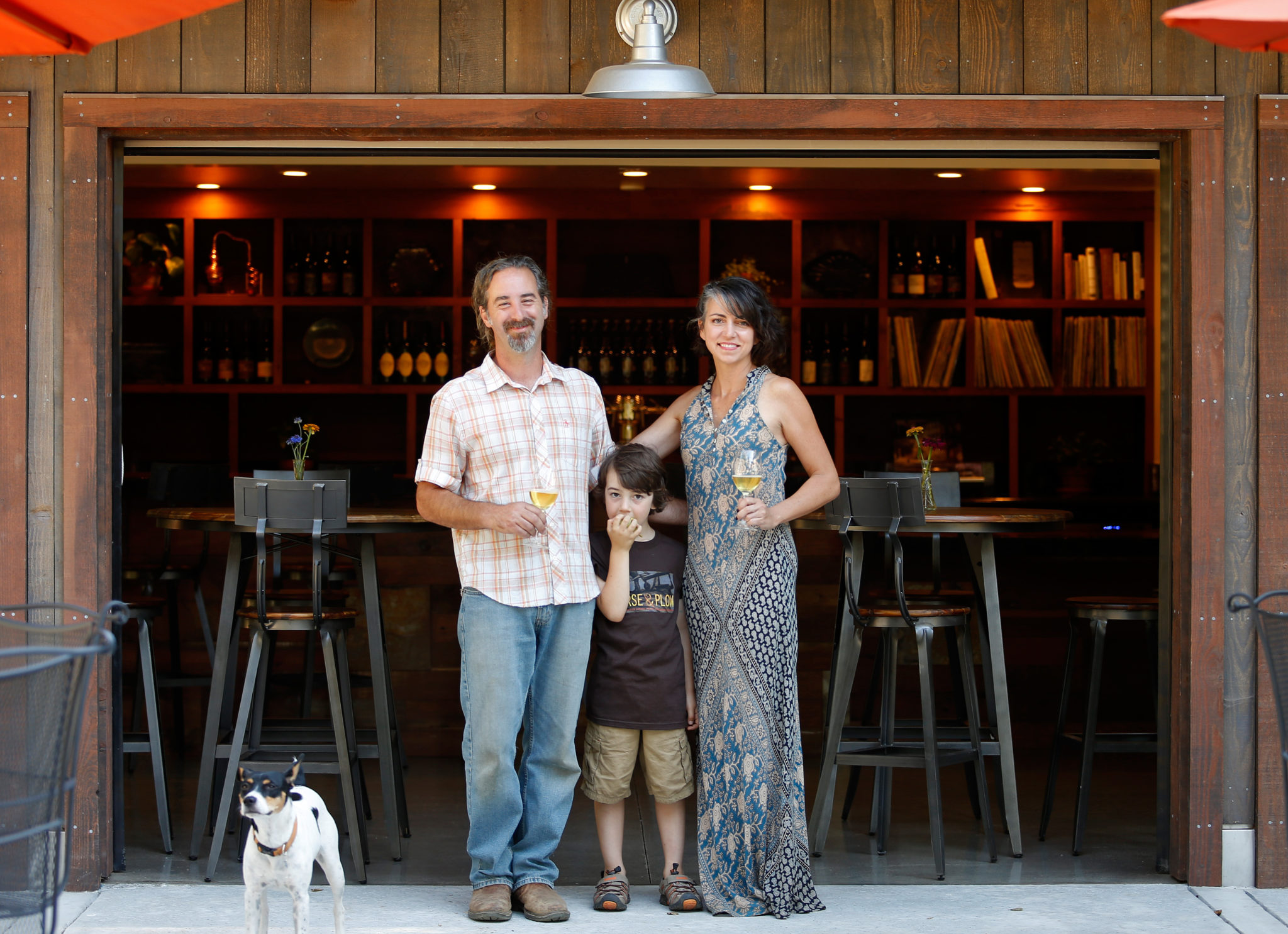 Horse and Plow winery owners and cidermakers Chris Condos and Suzanne Hagins with their son Dean Condos and family dog Pepita, at Horse and Plow winery in Sebastopol, California on Wednesday, July 27, 2016. (Alvin Jornada / The Press Democrat)