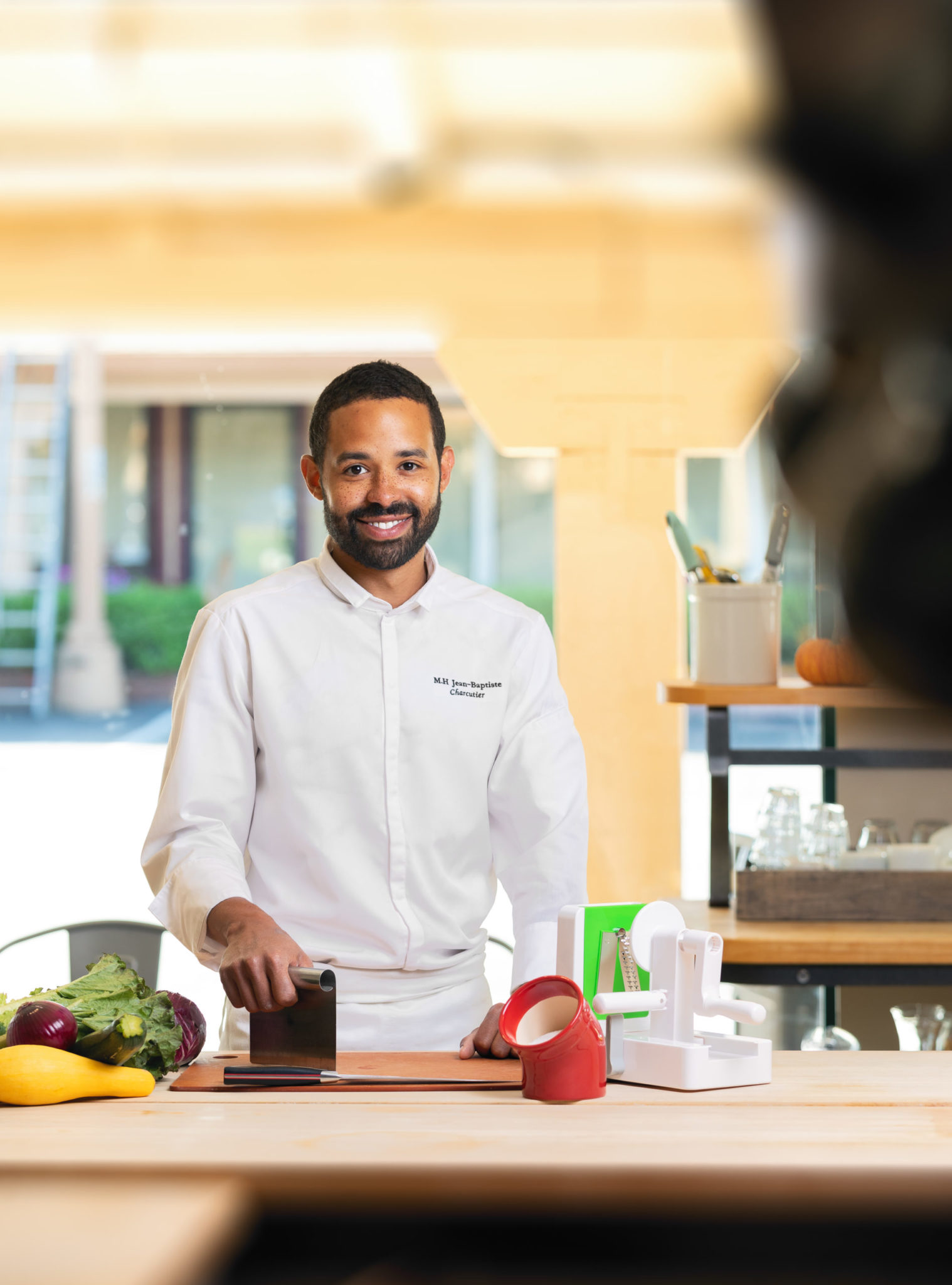 Chef Marc-Henri Jean-Baptist, instructor at Sur la Table with kitchen tools spiralizer ceramic salt cellar stainless steel scraper