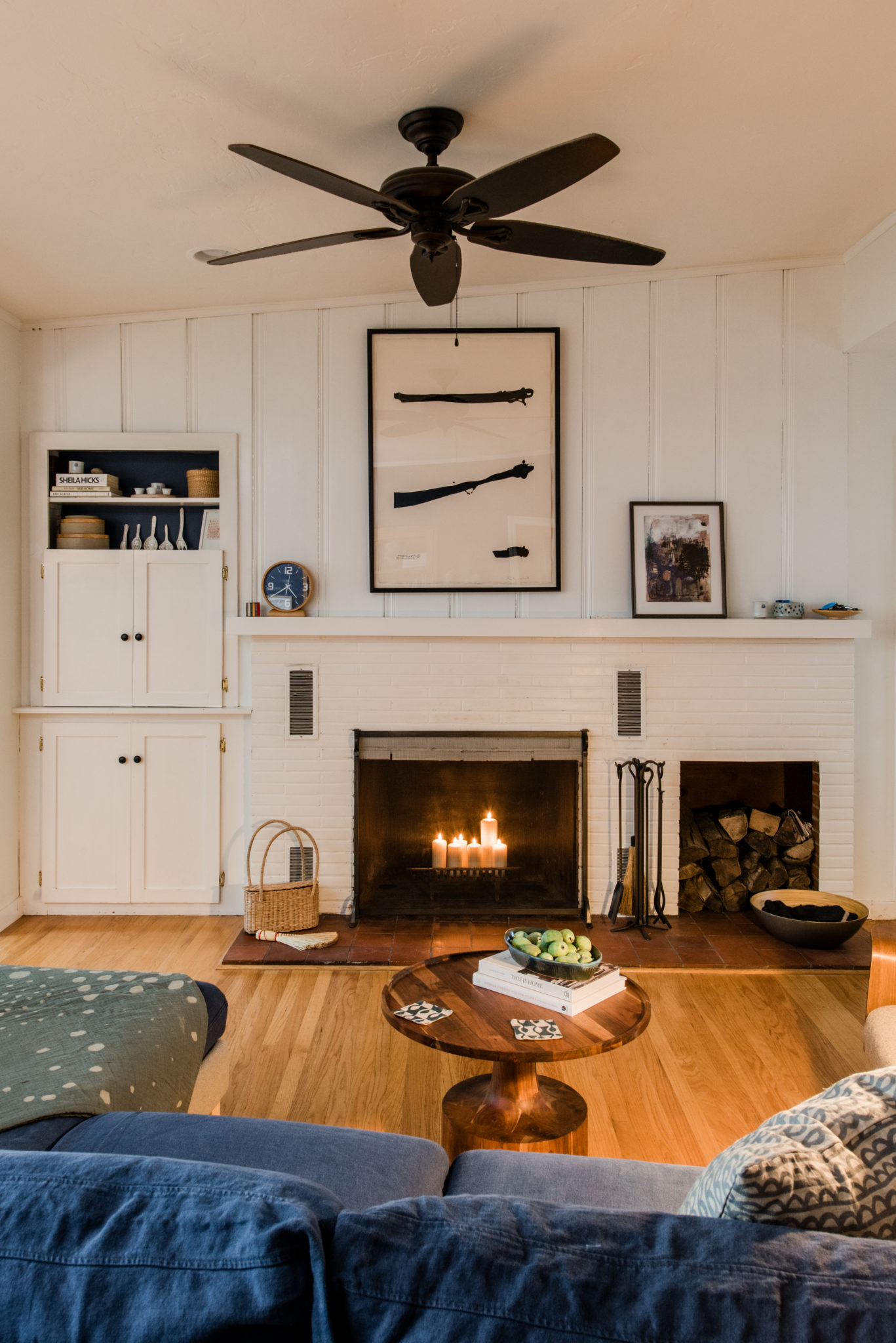 Black and beige large paper piece over fireplace is a Robert Motherwell print. Small piece next to it is by Lari Washburn