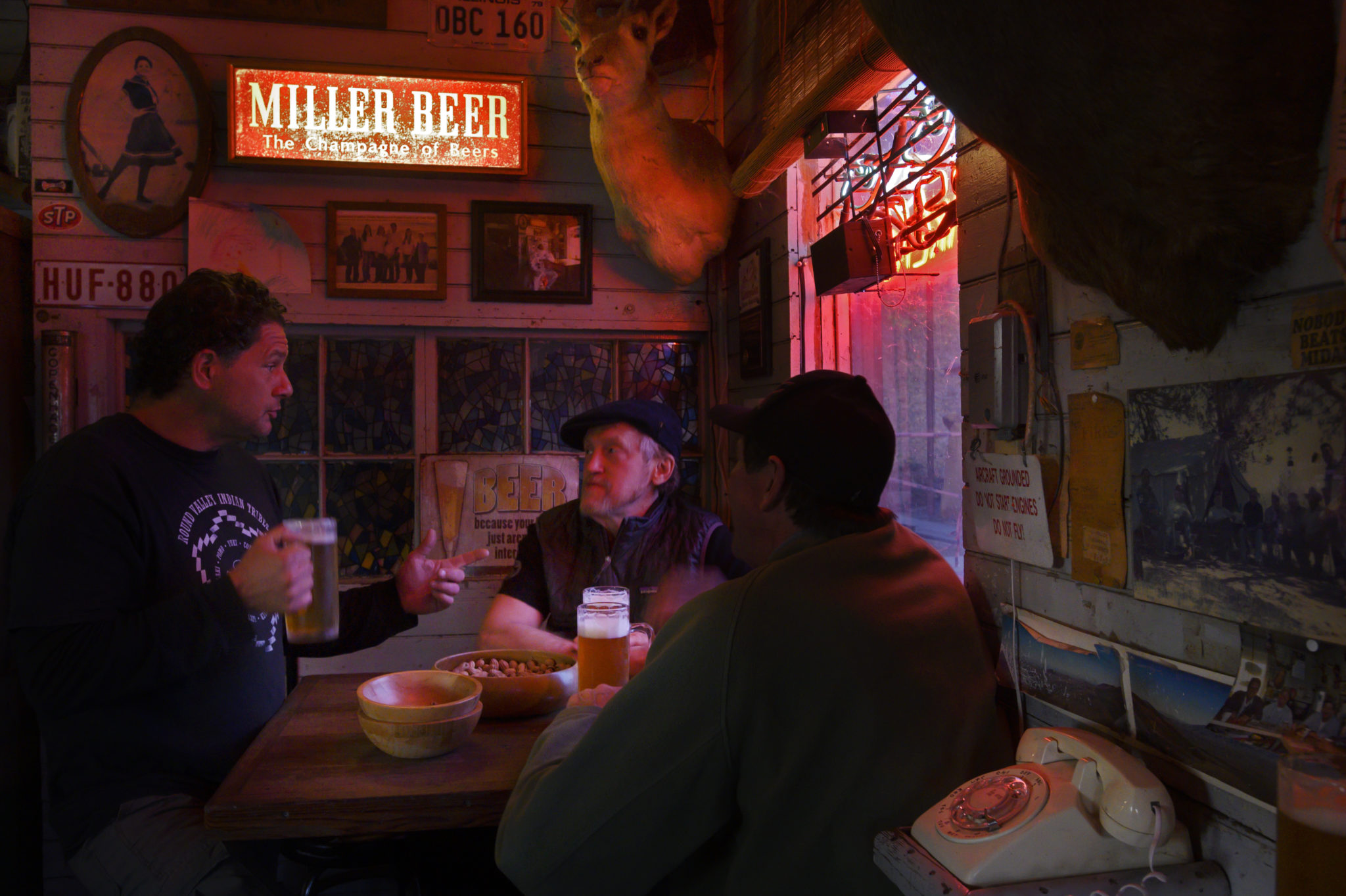 A few friends chat over beers and peanuts at Ernie's Tin Bar on Lakeville Highway in Petaluma. (Erik Castro/for Sonoma Magazine)