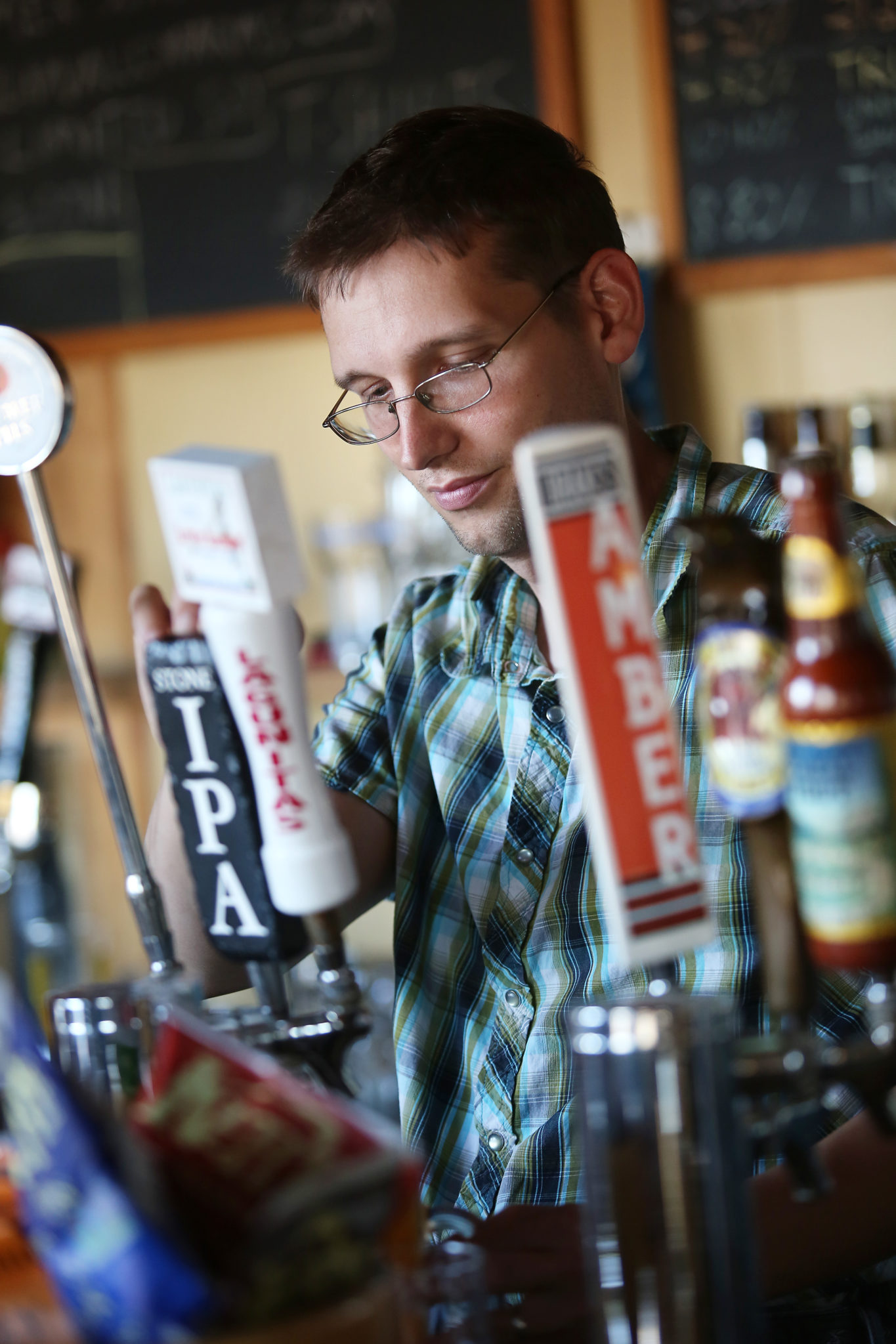 Bartender and owner Ernie Altenreuther pours drinks for his regular customers at Ernie's Tin Bar in Petaluma on Wednesday, July 31, 2013. (Conner Jay/The Press Democrat)