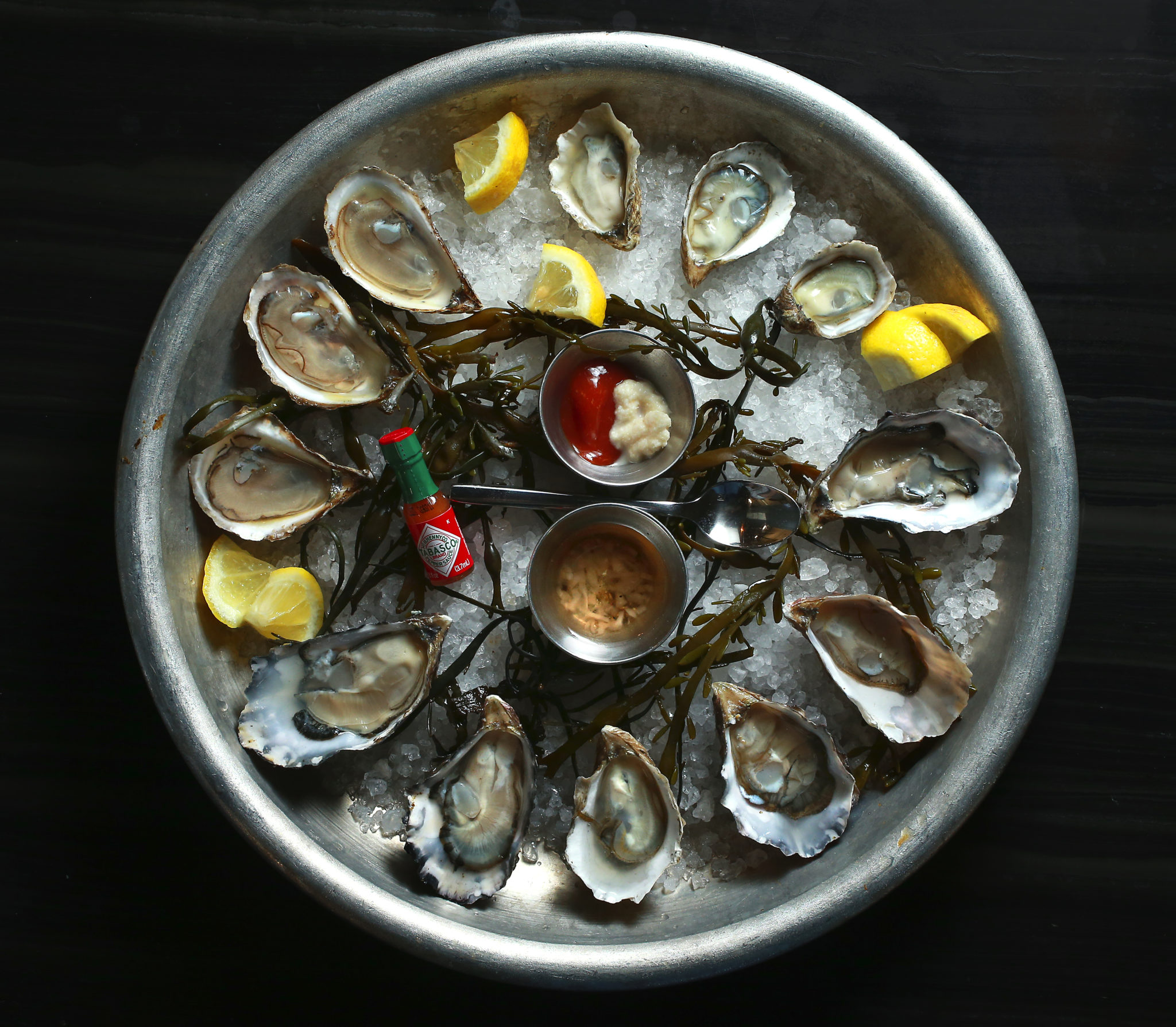 The Dozen Oysters plate at The Shuckery in Petaluma includes St. Simone, Kumamoto and Hog Island oysters. (John Burgess / The Press Democrat)