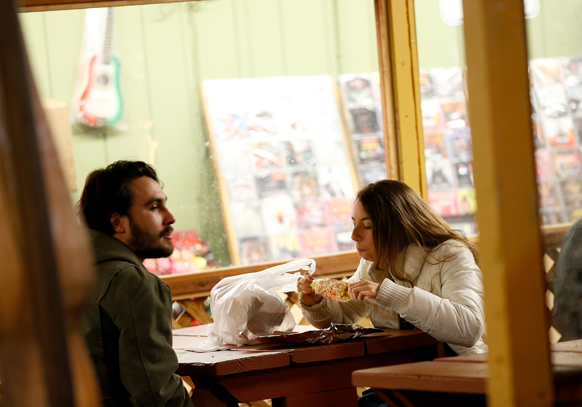 Julia Ingalls, right, and Evan Marquez, both of Santa Rosa, share some elote at La Fondita restaurant in the Roseland neighborhood of Santa Rosa, California, on Friday, February 15, 2019. (Alvin Jornada / The Press Democrat)