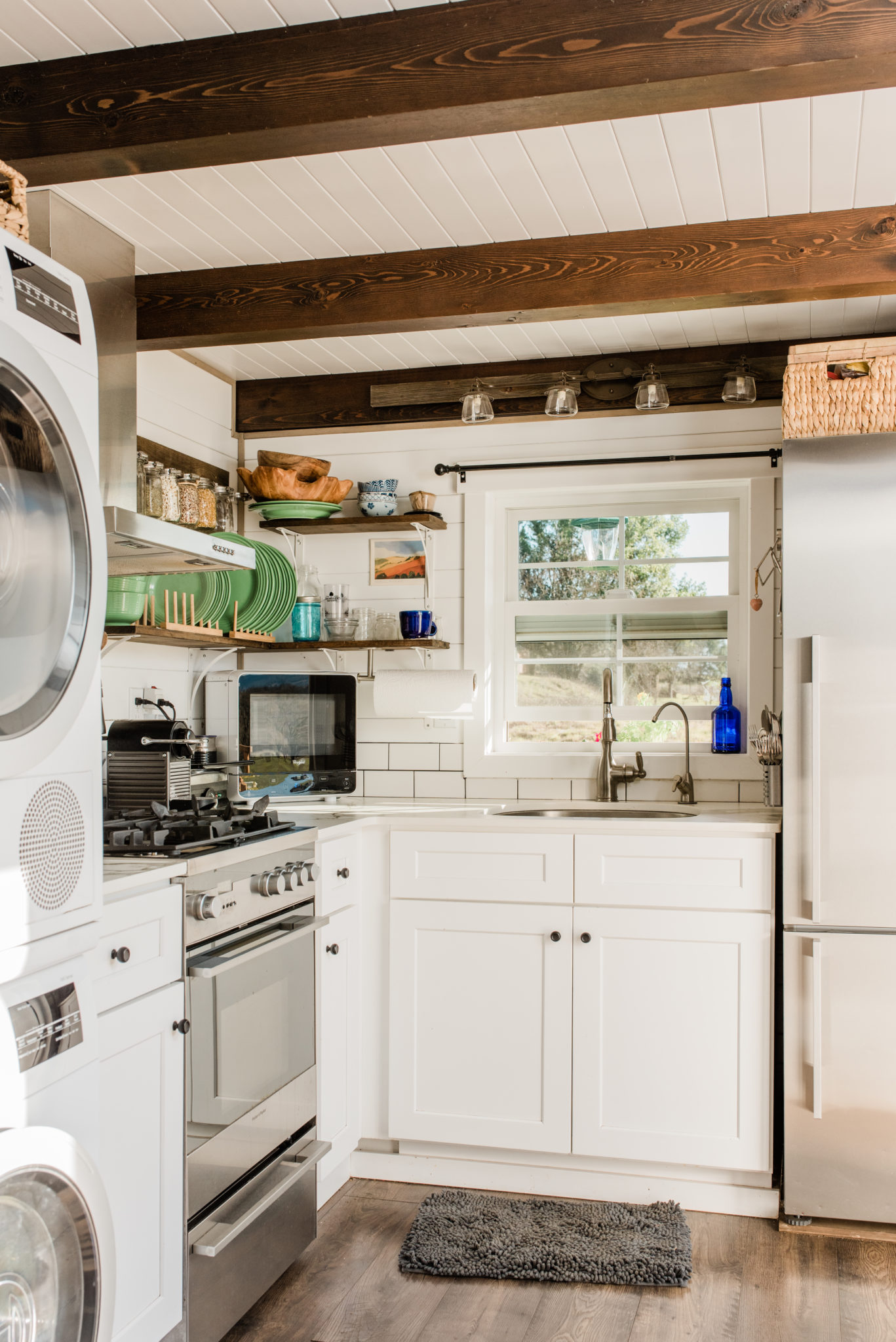 Laundry and kitchen share front entry corner of the tiny home.