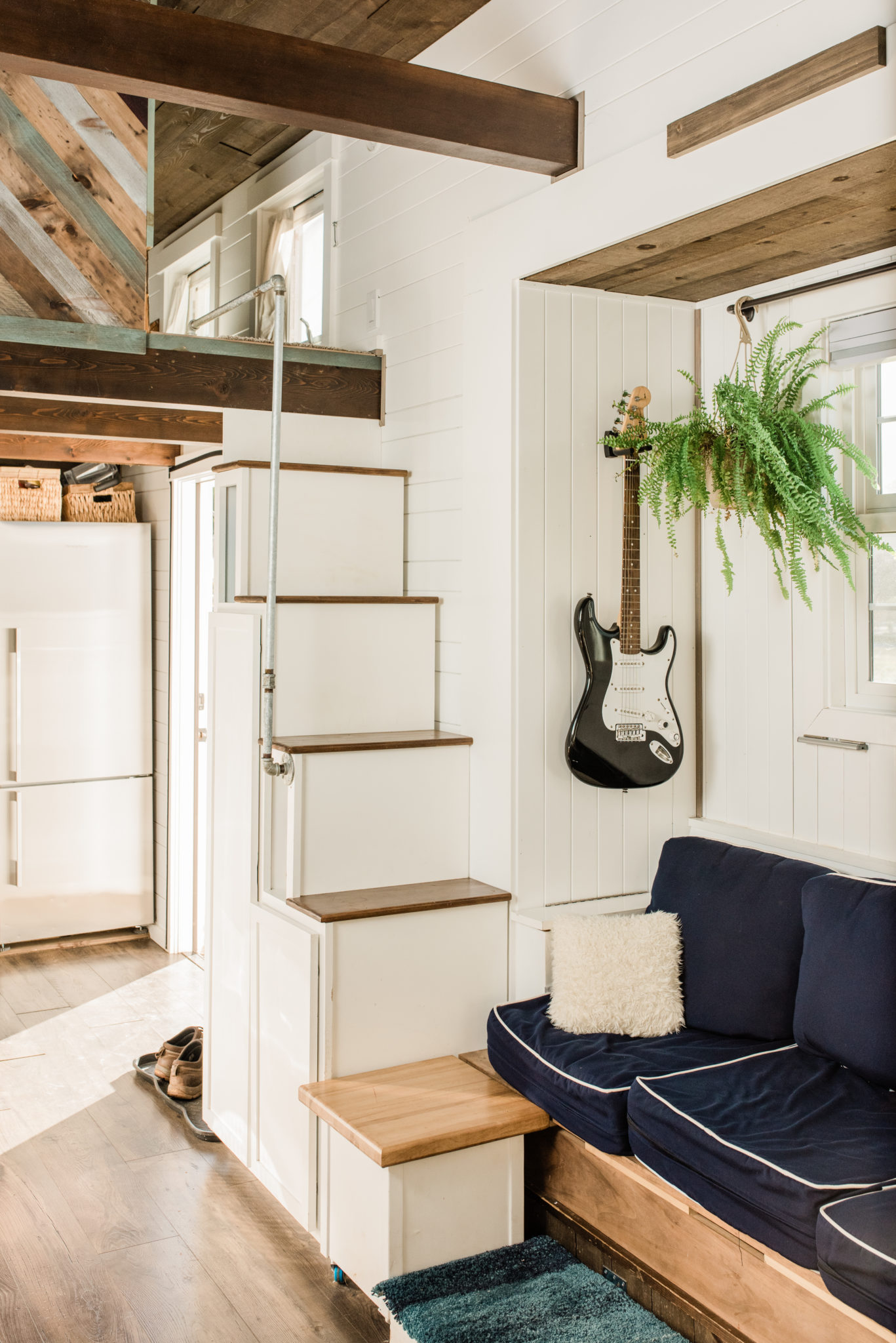 Main living space in the tiny home. Nearly every surface (including the stairs) opens up to some sort of storage space. Their are two loft bedrooms (one for the boys and one for Jennifer and Justin.