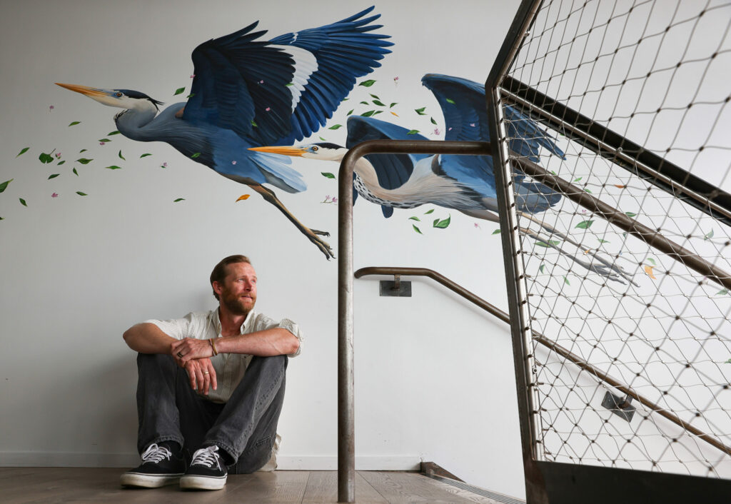 Artist Jake Messing poses with his “Blue Harmon” mural, which spans the staircase at Harmon Guest House in Healdsburg on Monday, September 16, 2024. (Christopher Chung/The Press Democrat)