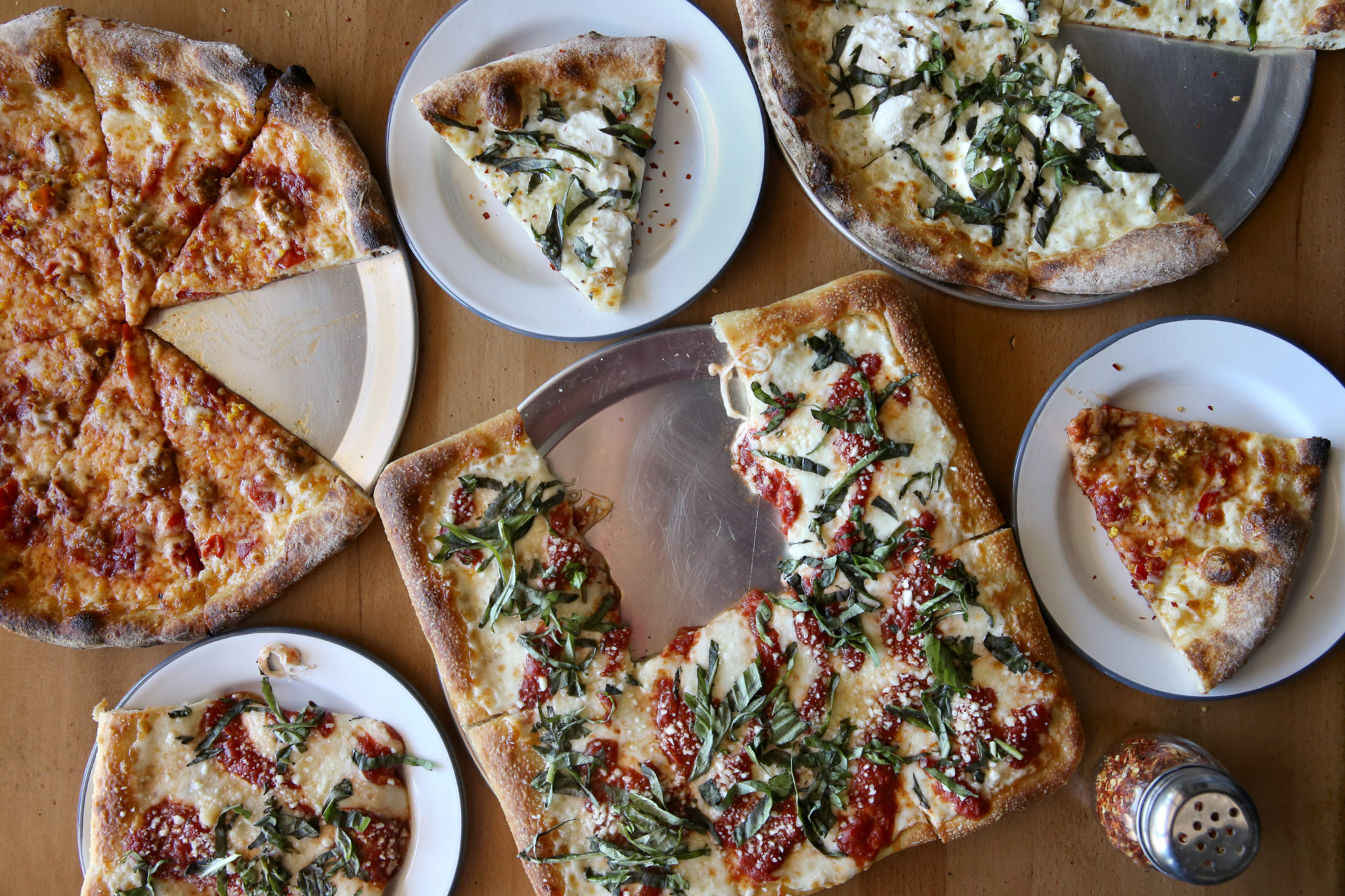 A variety of pizzas including the Old Grey Beard, left, featuring Italian sausage, Calabrian peppers, hot honey and orange zest, the Spayde, center, a square pan pizza with red sauce, mozzarella, pecorino, olive oil and fresh basil, and the Chingona, top, featuring olive oil, garlic, mozzarella, ricotta and fresh basil at PizzaLeah in Windsor, Calif., on Wednesday, May 27, 2020. (Beth Schlanker / The Press Democrat)