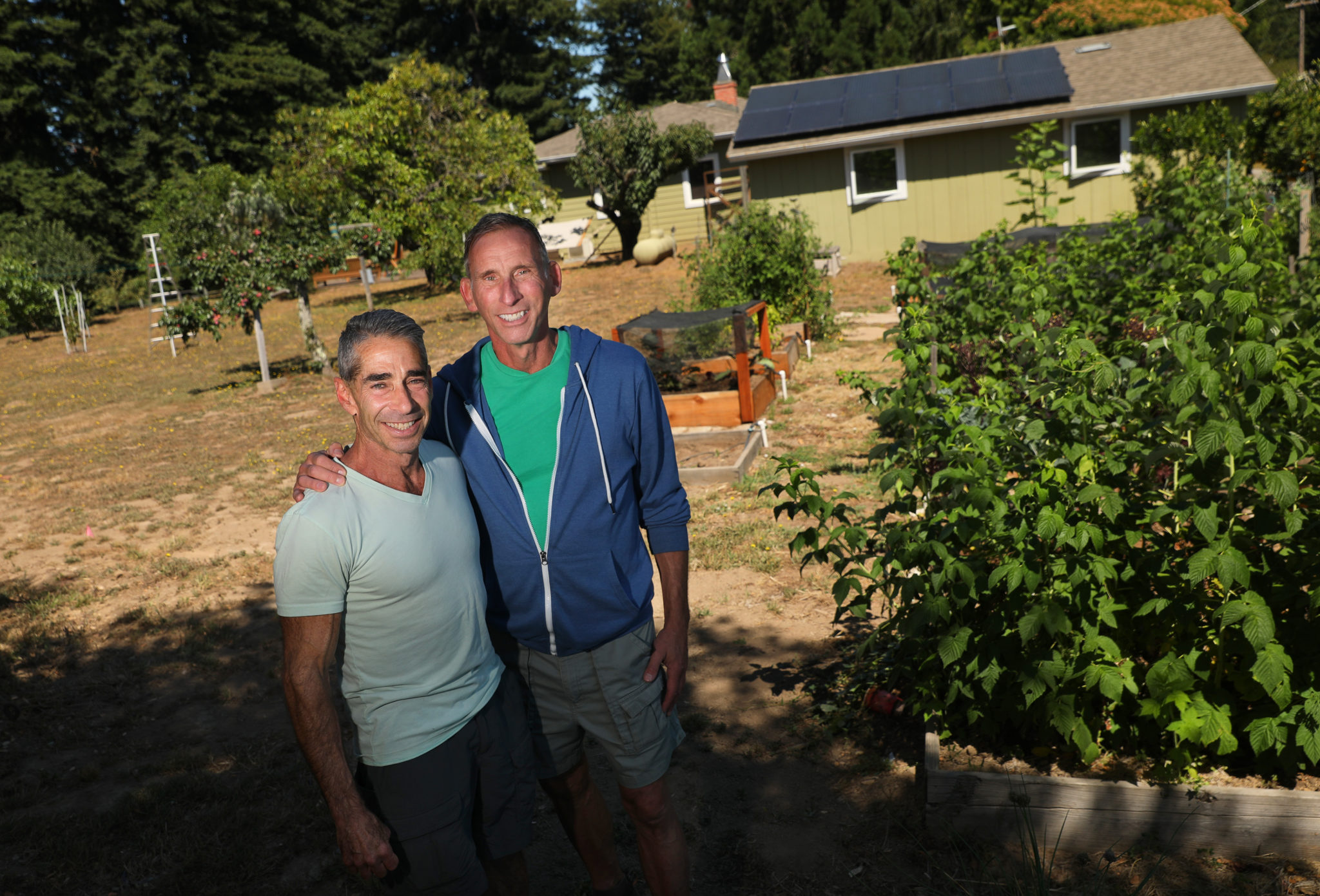 Tony DeYoung, left, and Joe Metro installed solar panels and added a solar storage battery at their property near Occidental. (Christopher Chung / The Press Democrat)