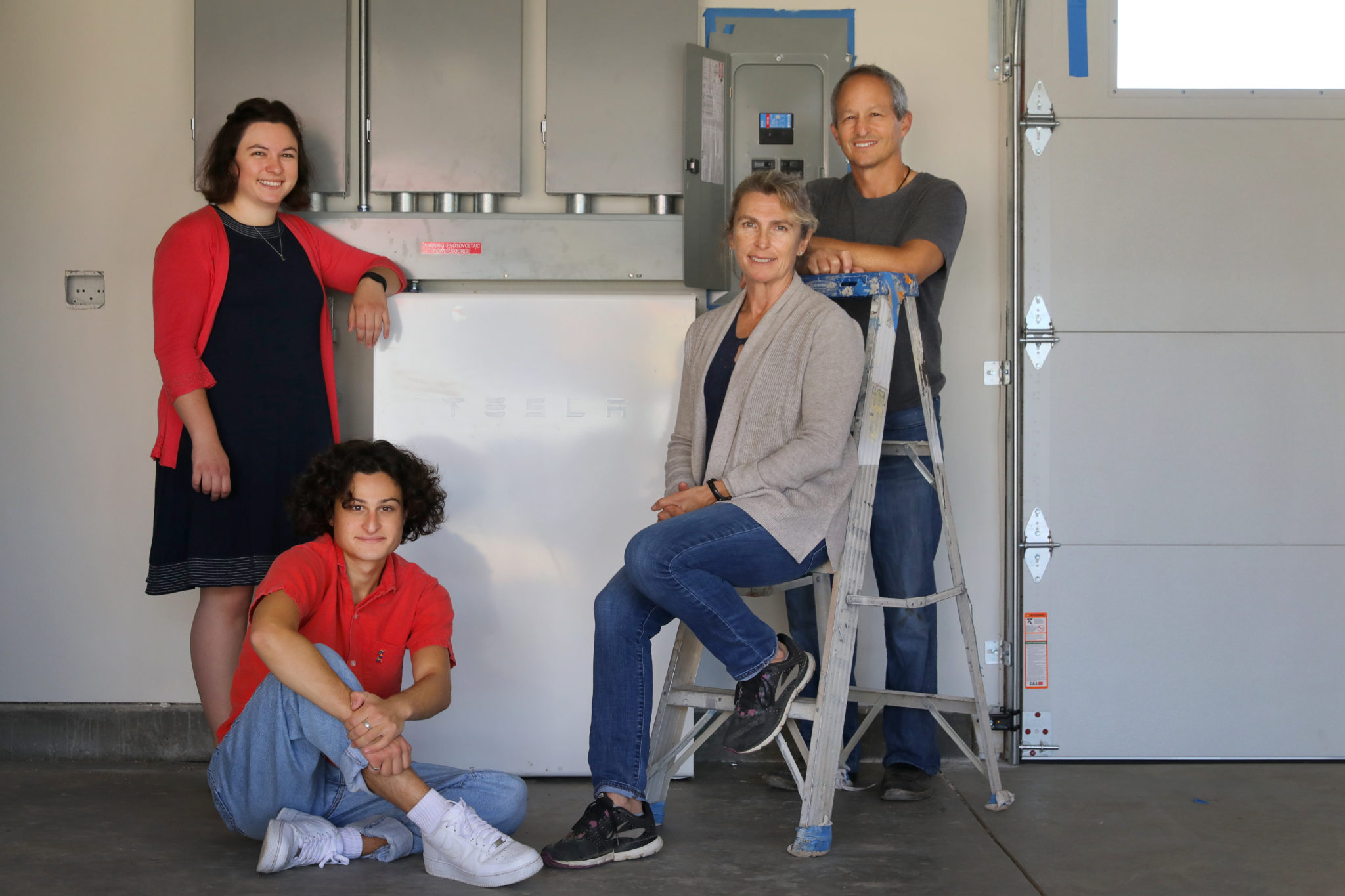 Joshua Weil, right, and his wife Claire Mollard, with their children Caleb and Sydney Weil have installed two Tesla Powerwalls along with solar panels into their rebuilt home, in Santa Rosa. (Christopher Chung / The Press Democrat)