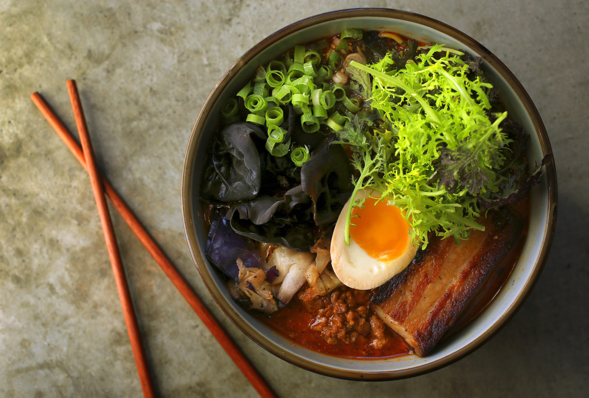 Spicy Tan Tan Ramen with Sapporo noodles, sesame, scallion, pork belly chashu, spicy ground pork, charred cabbage, woodier and a 6-minute egg from Ramen Gaijin in Sebastopol. (John Burgess/The Press Democrat)