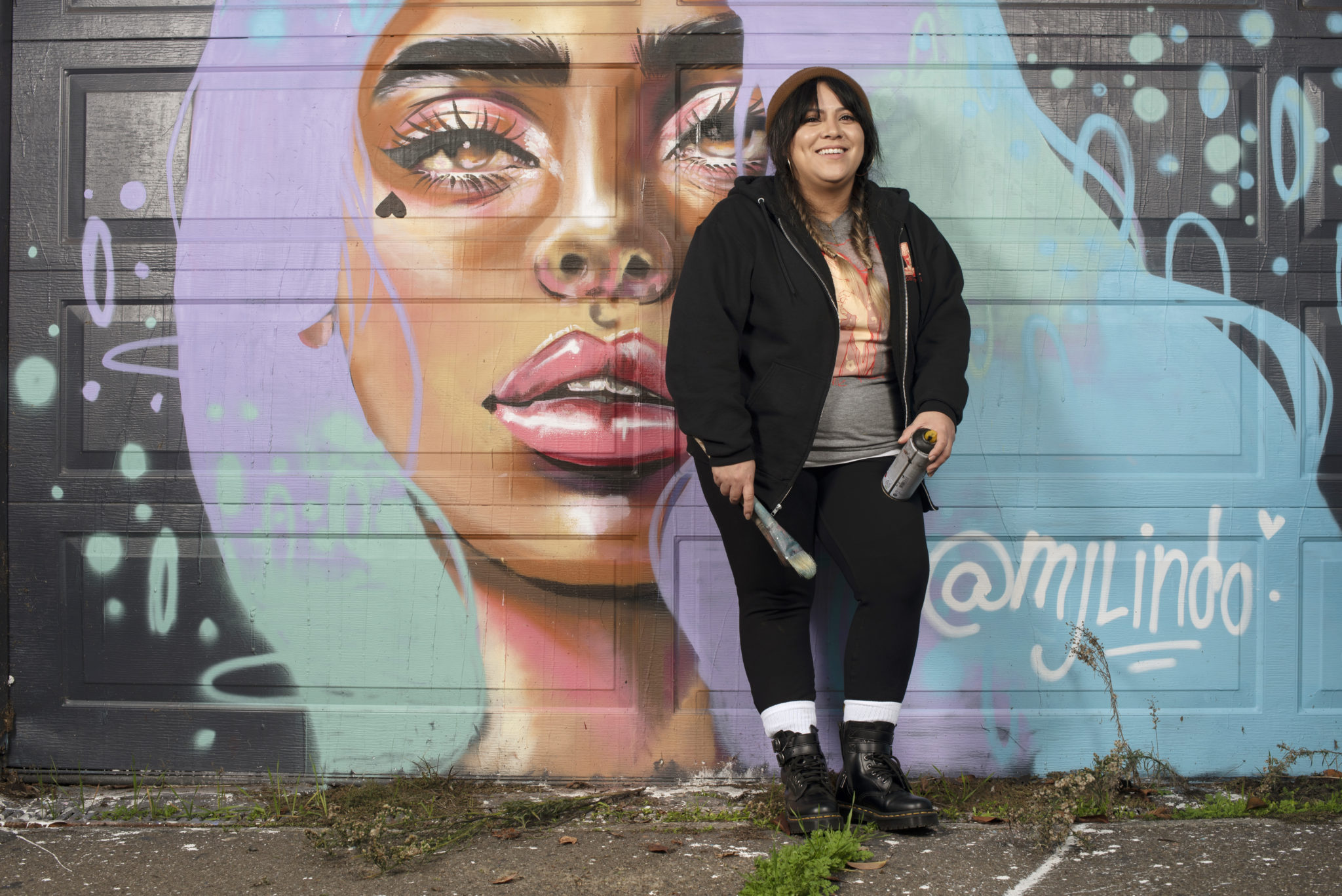 Painter and street mural artist MJ Lindo-Lawyer at a mural she created on a building on Santa Rosa Avenue near highway 12 in Santa Rosa, California. January 13, 2021. (Photo: Erik Castro/for Sonoma Magazine)