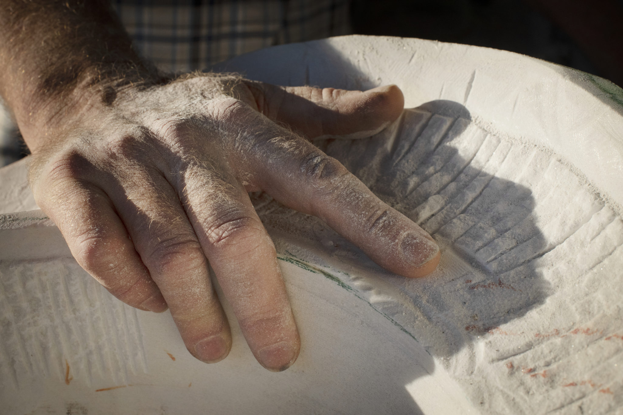 Stone sculptor T BarnyÕs hand on a block of Carrara statuario marble at his workshop in Healdsburg, California on January 14, 2021. (Photo: Erik Castro/for Sonoma Magazine)