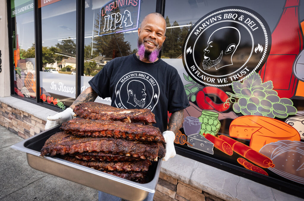 Marvin Mckinzy removes his slow-cooked tri-tip from the grill at Marvin’s BBQ and Deli Wednesday, August 30, 2023 in Sebastopol. (Photo John Burgess/The Press Democrat)