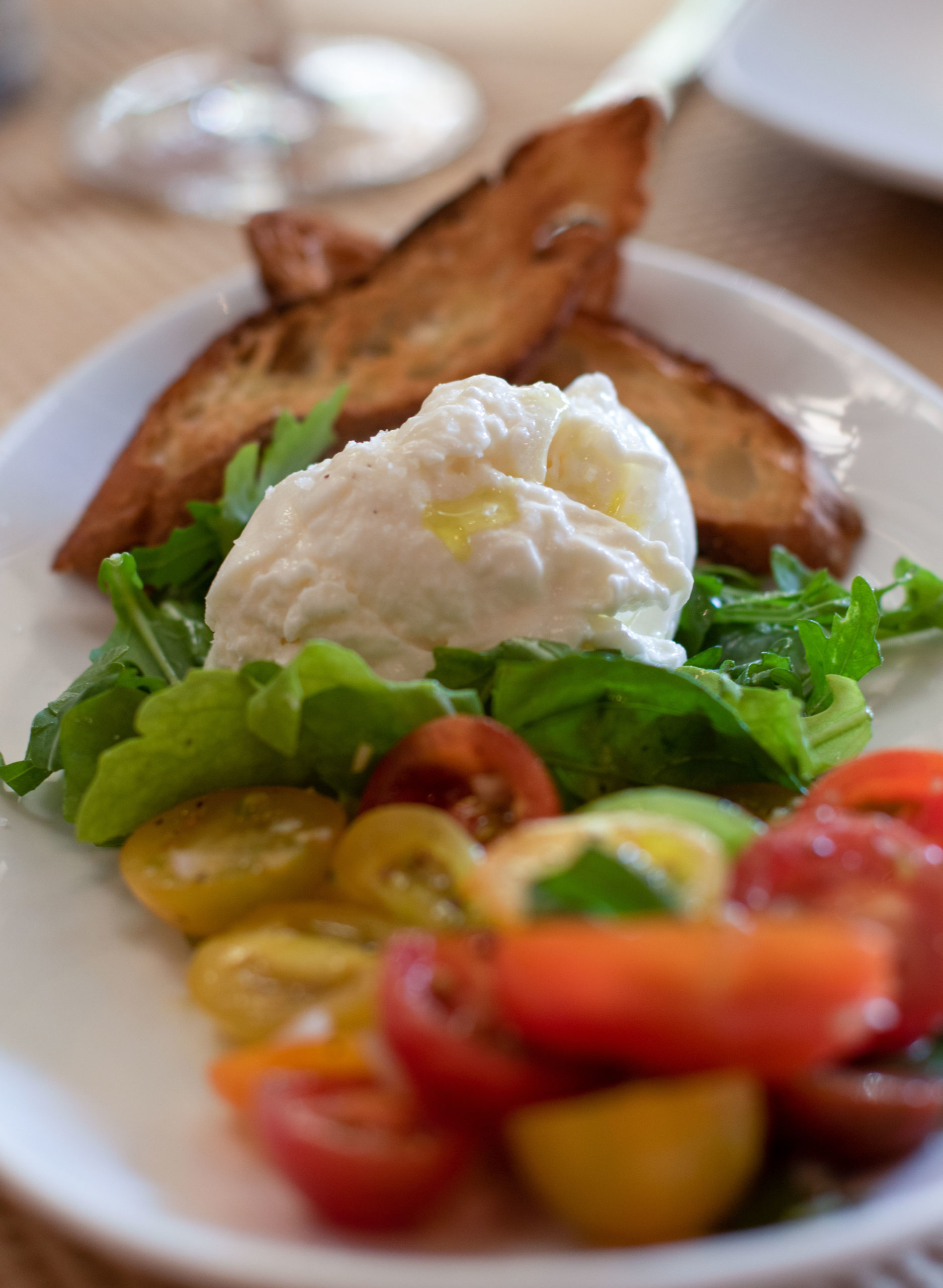 Burrata with cherry tomatoes, capers and crostini at Central Market in Petaluma. (Heather Irwin/The Press Democrat)