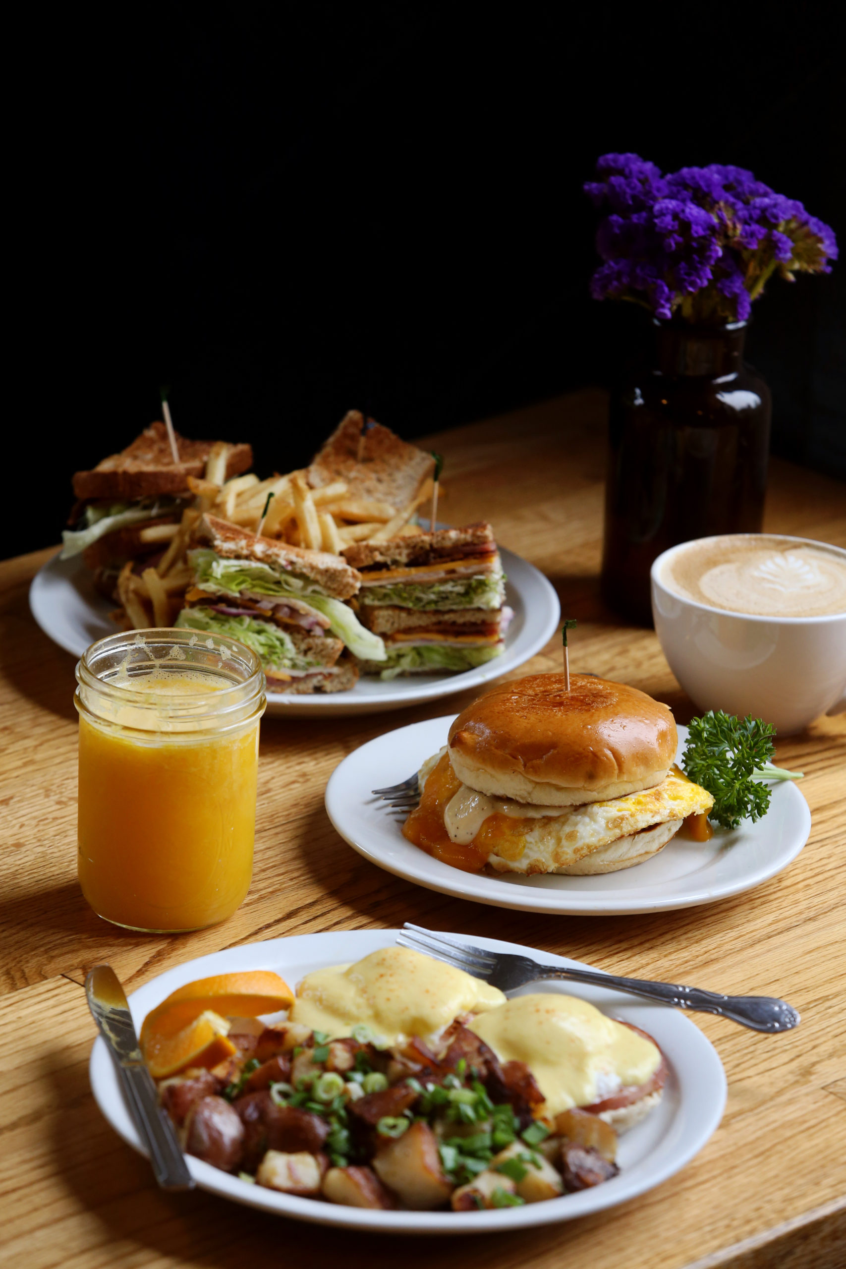 (From front) The original Eggs Benedict, the Howard&apos;s Egg Sandwich, the Howard's Club sandwich, freshly squeezed orange juice and a cappuccino at the Howard Station Cafe in Occidental, Calif., on Thursday, May 13, 2021. (Beth Schlanker/Sonoma Magazine)